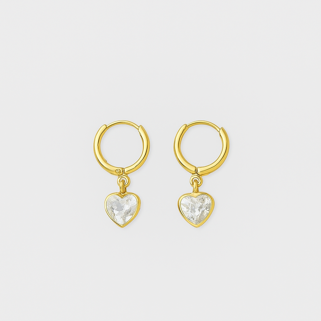 Gold heart-shaped earrings with clear stones on a light gray background