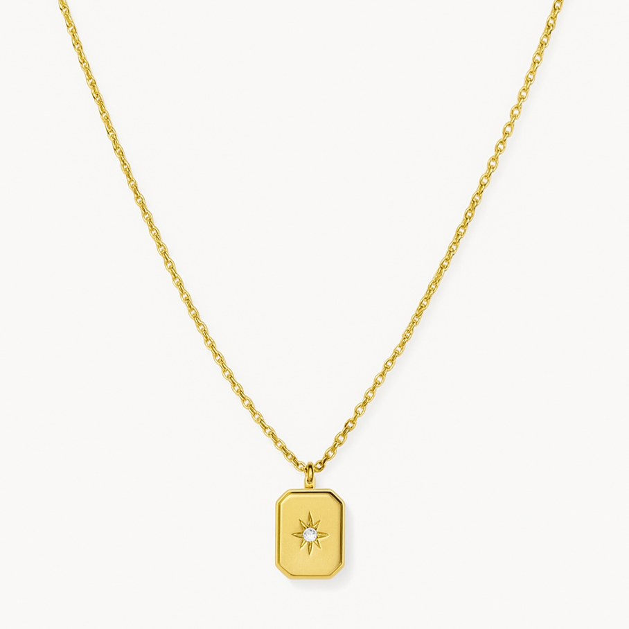Gold necklace with a star pendant on a white background