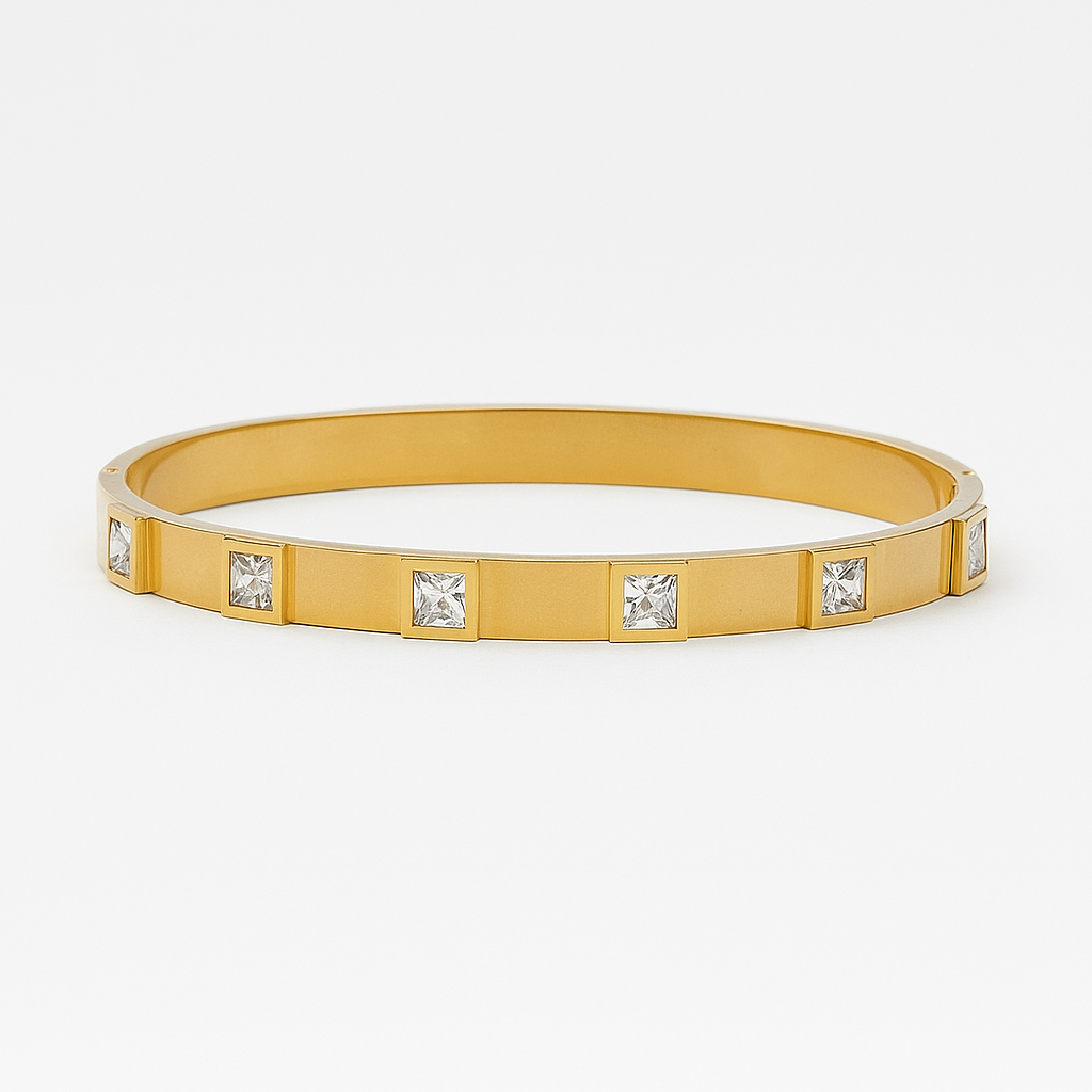 Gold bracelet with embedded crystals on a white background