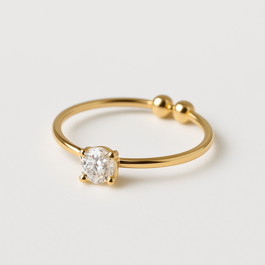 Gold ring with a diamond on a light gray background
