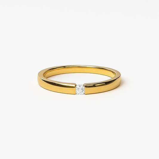 Gold ring with a diamond on a white background