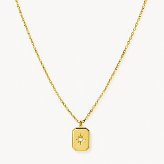 Gold necklace with a star pendant on a white background