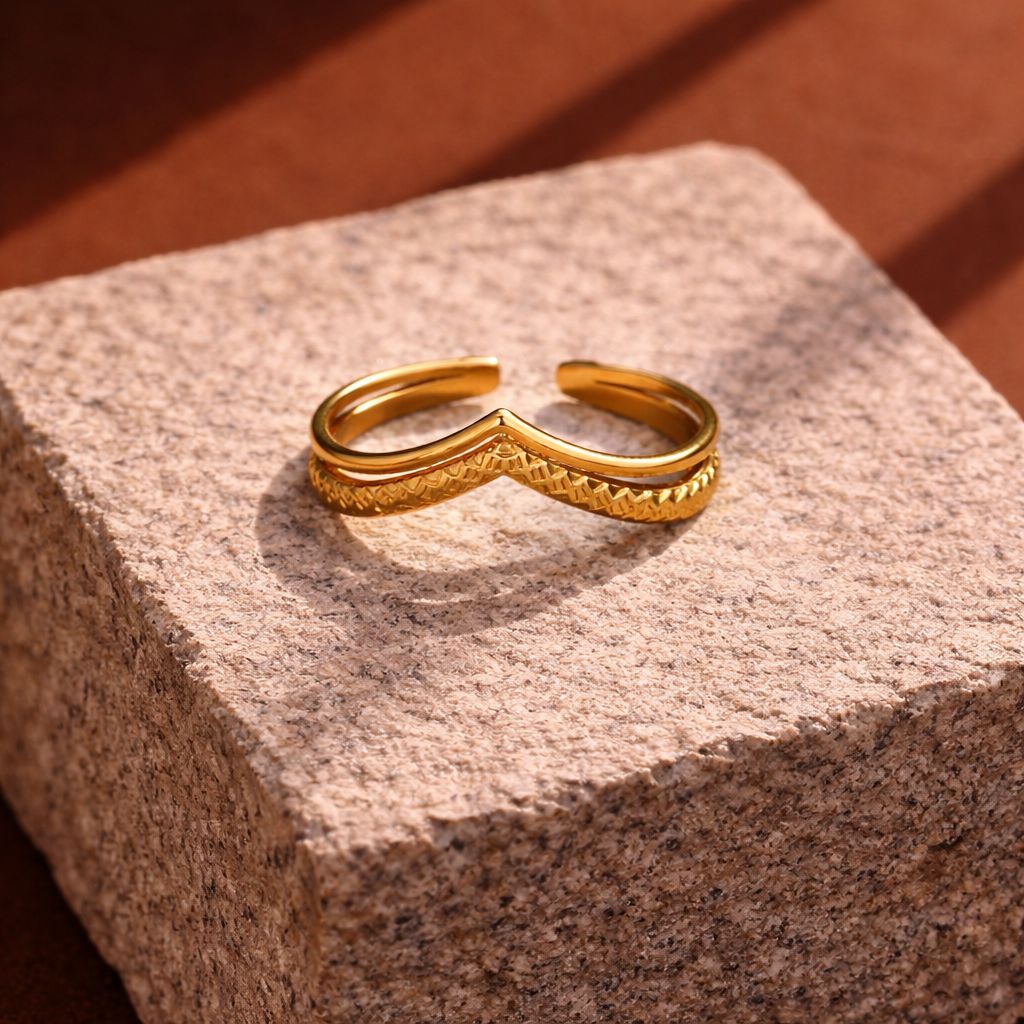 Gold bracelet on a textured stone surface