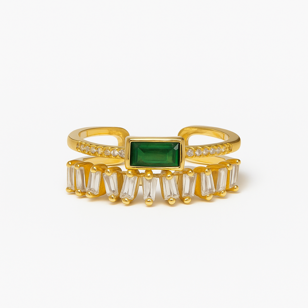 Gold ring with a green gemstone on a white background