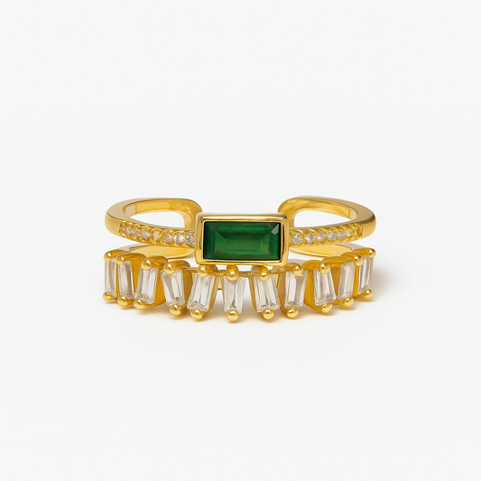 Gold ring with a green gemstone on a white background