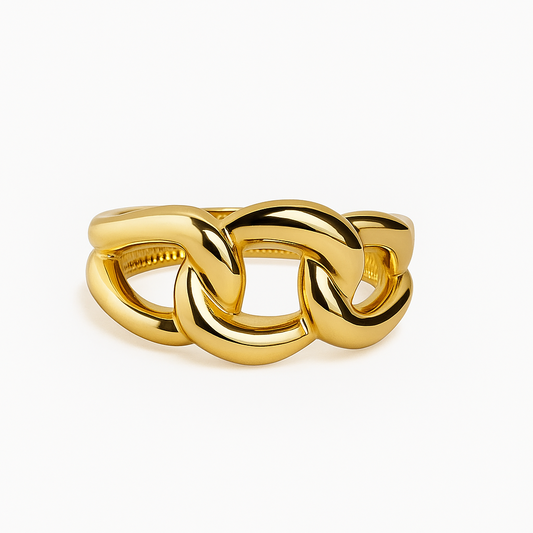 Gold chain-style ring on a white background