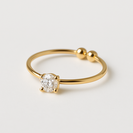 Gold ring with a diamond on a light gray background